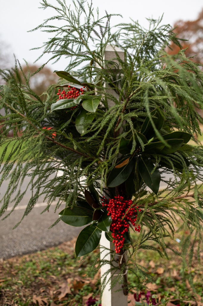 backside view of mailbox decorated with evergreens